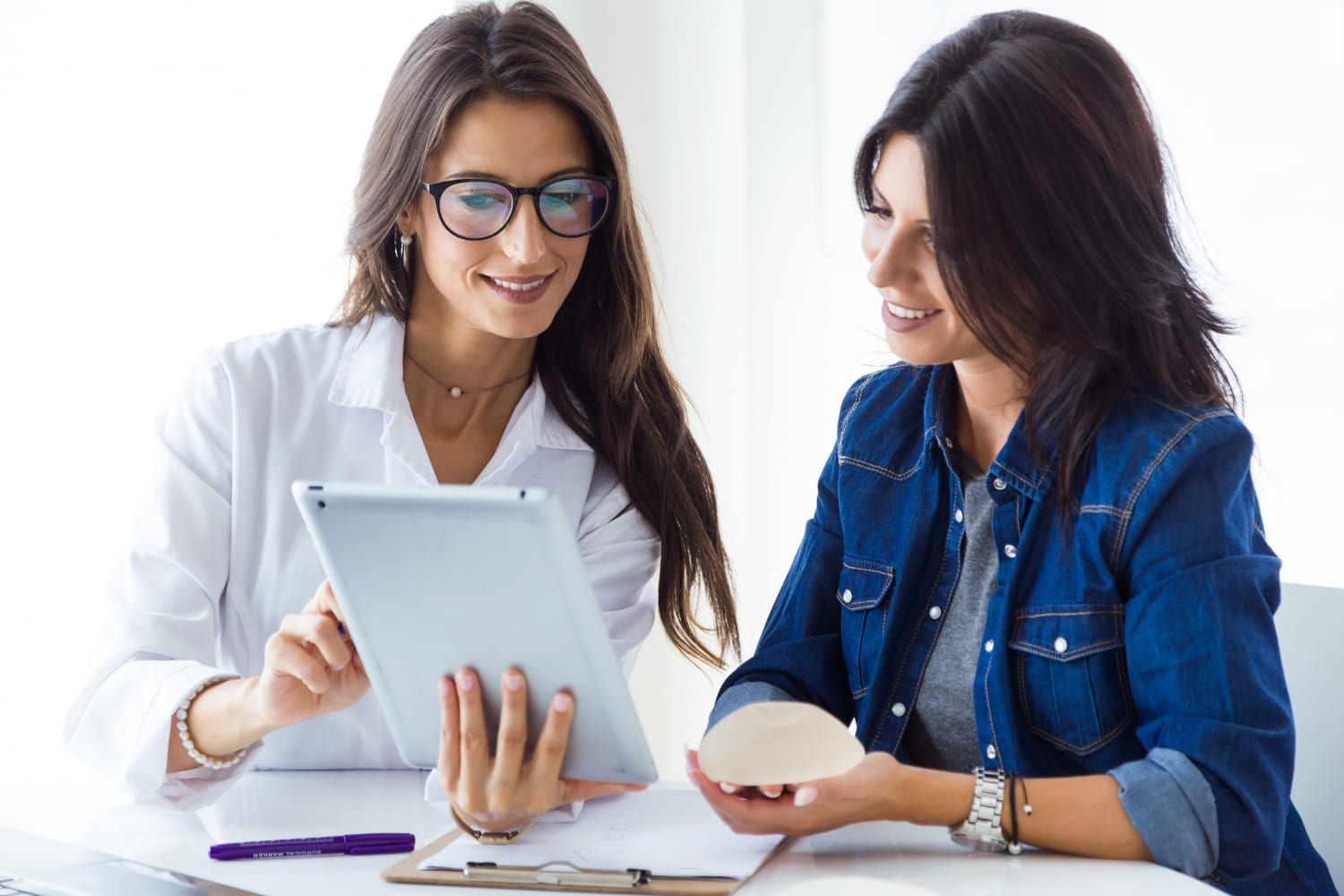 Doctor And Her Patient Choosing Mammary Prosthesis In The Office11